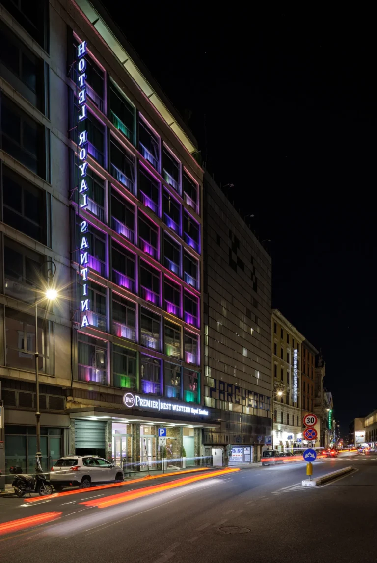 Nell'immagine si vede l'entrata e la bia esterna dell' Hotel illuminata di sera.