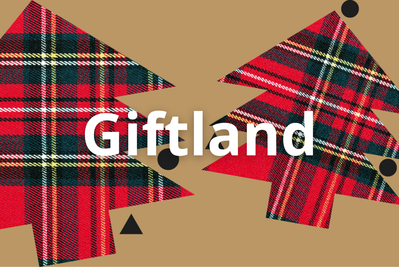 L'immagine rappresenta la locandina dell'evento con 2 sagome di abeti fatte in tessuto scozzese e la scritta giftland in mezzo